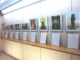 額に入った仏像などの文化財の写真が壁一面に展示されている展示コーナーの写真
