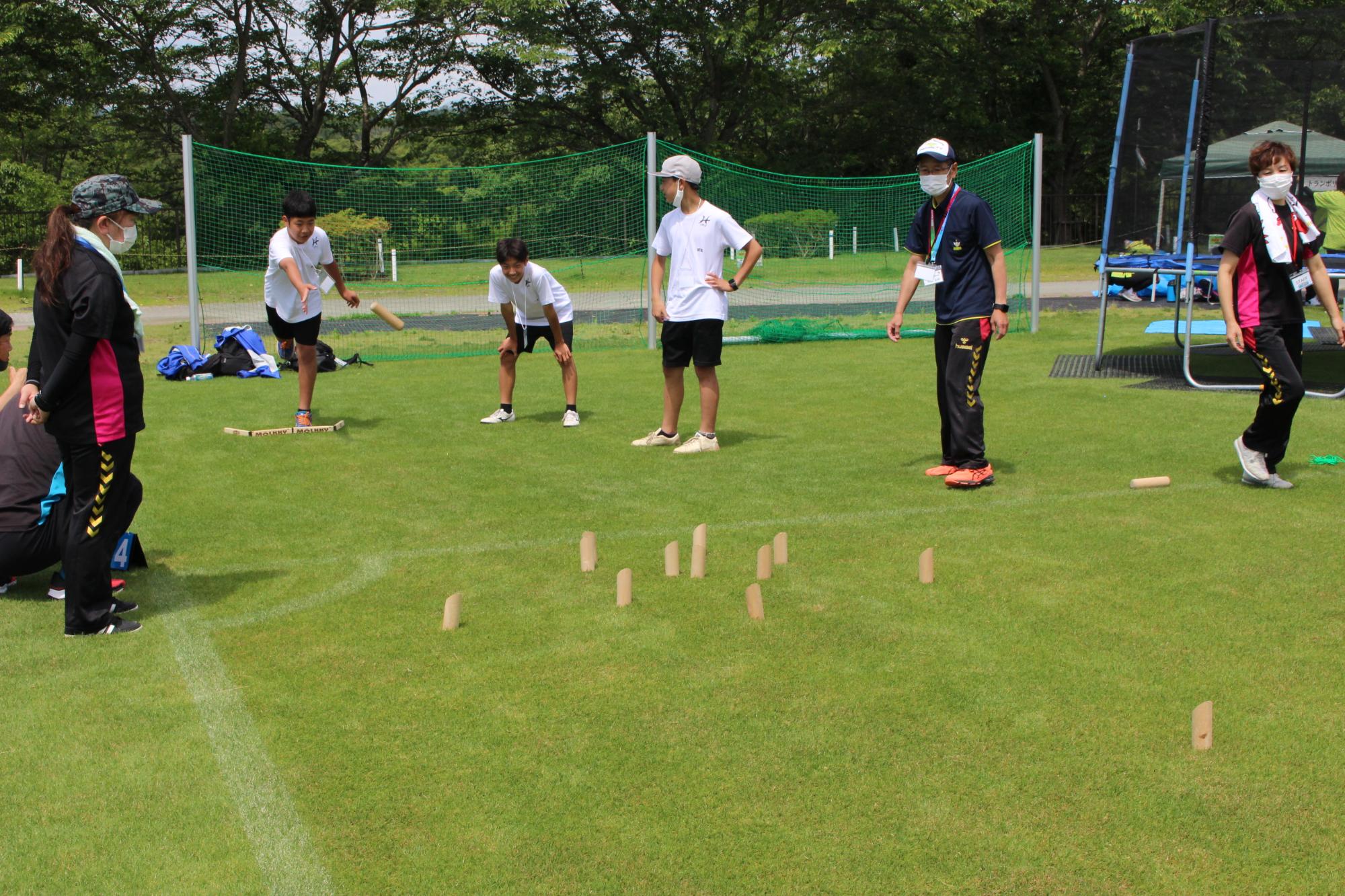 スポレク祭で男の子が3人がモルックで遊んでいるところ